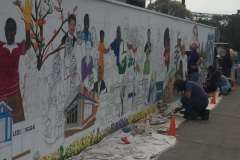 Artists paint the mural in late July 2018