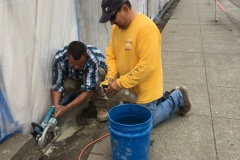 Workers prepare to lay concrete base for tiles