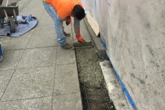 Worker lays concrete base for tiles