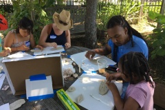 Community members design tiles to go at base of mural